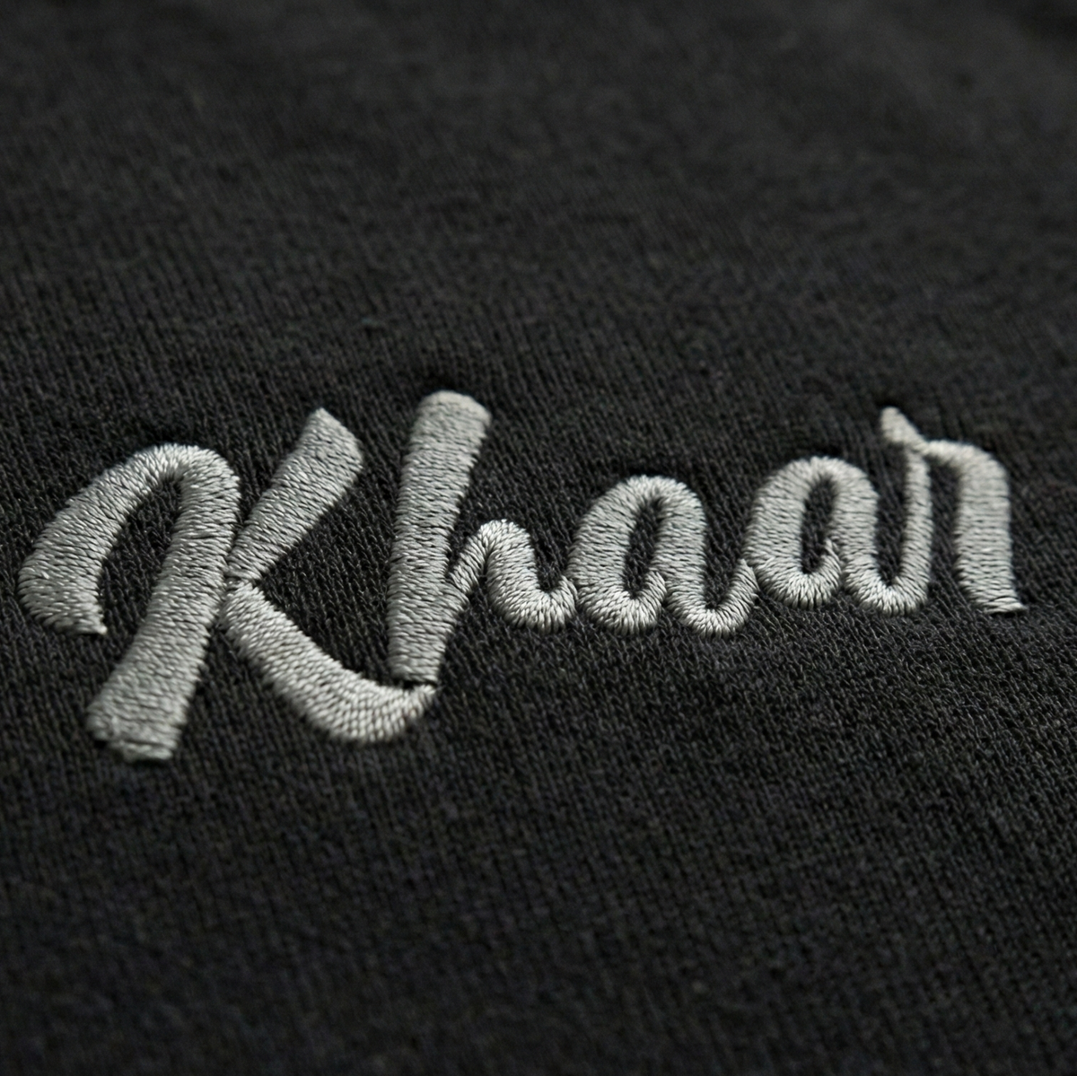 Black 1947 Crewneck front — stitched Khaar Studios branding at chest