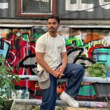 OG Karachi Tee Cream White front — Ajrak print and Khaar Urdu logo at hem
