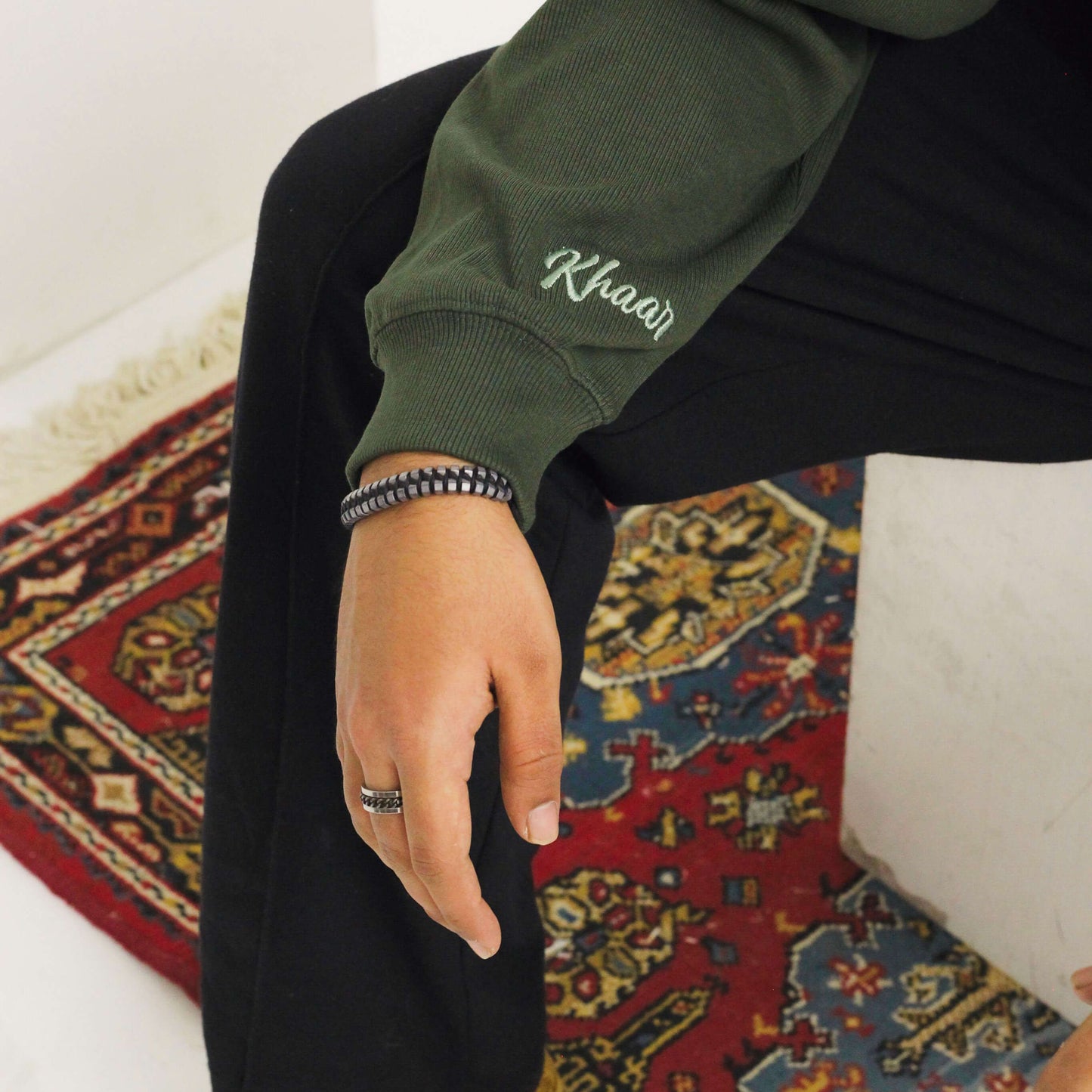 Khaar Markhor Knit Sweater in Forest Green – Logo detail