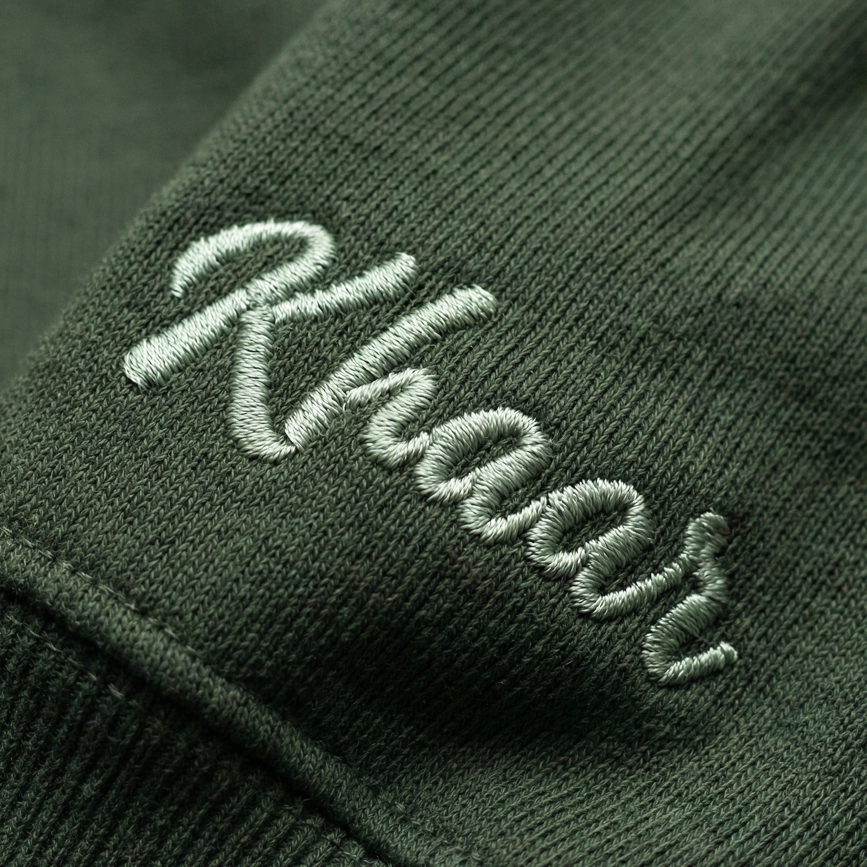 Khaar Markhor Knit Sweater in Forest Green – Emboridery detail