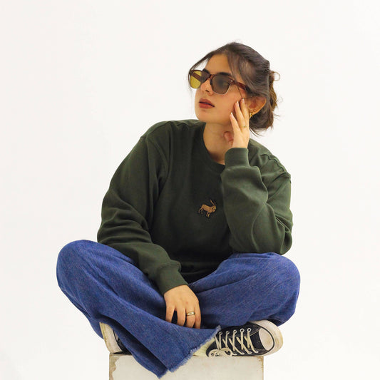 Khaar Markhor Knit Sweater in Forest Green – Female model sitting