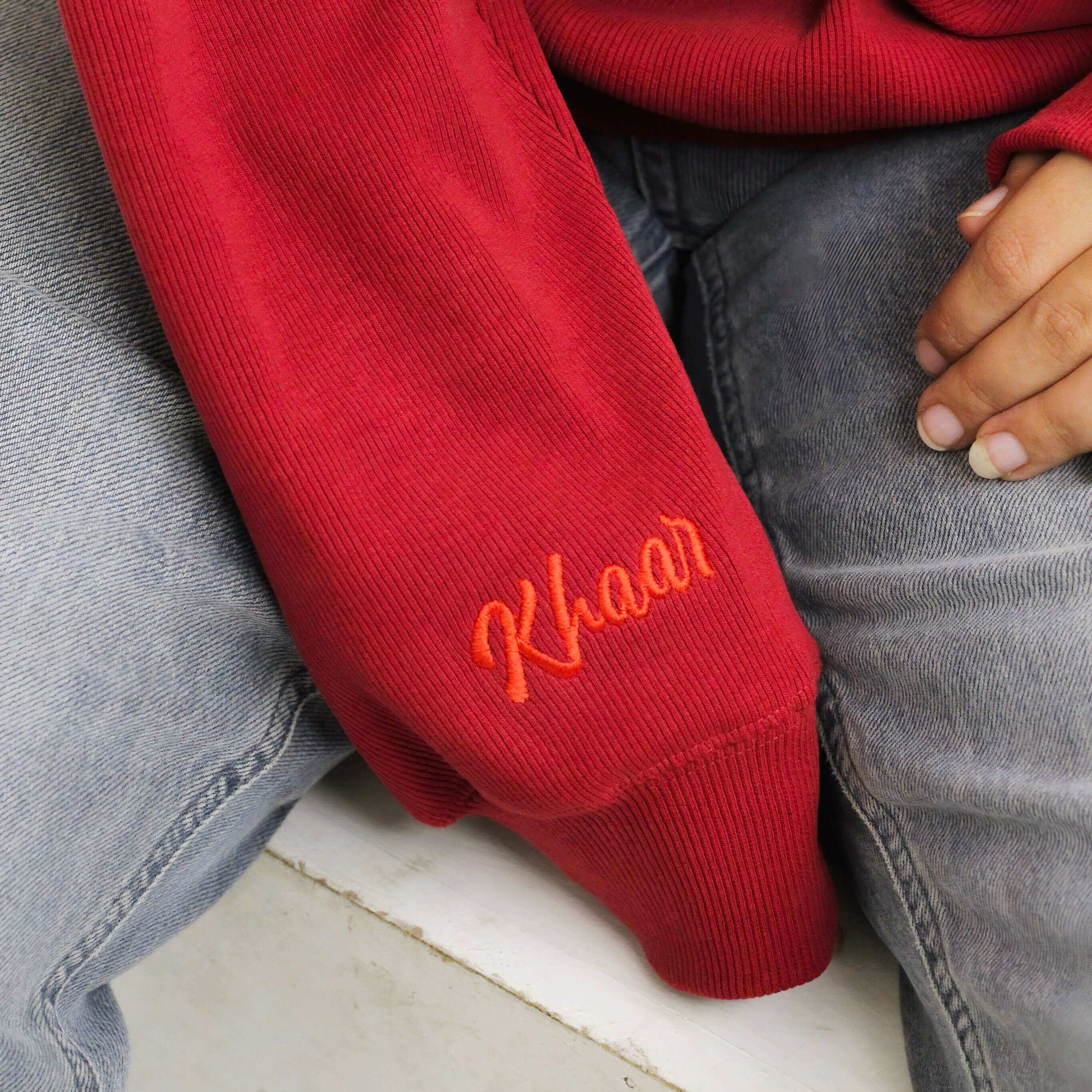 Khaar Markhor Knit Sweater in Maroon Red – Red logo closeup