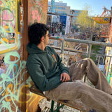 British Racing Green Hoodie back — Made in Pakistan Urdu typography in olive green
